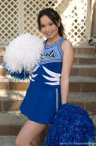 Sweet Teasing Asian American Cheerleader With Pom Poms